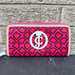Juicy Couture zip-around wallet featuring a pink geometric pattern